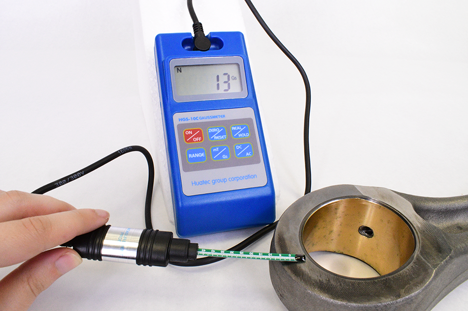 gaussmeter measuring magnetic field on steel pipe